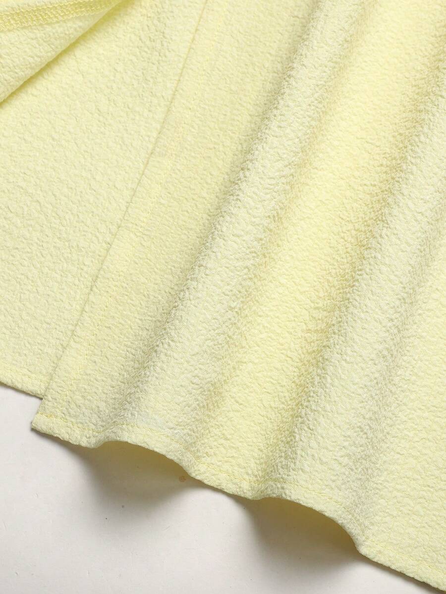 Tween girl yellow long halter dress with cutout waist, split detail, shirred textured fabric, sleeveless design, high waist, and flared hem for beach vacation wear.
