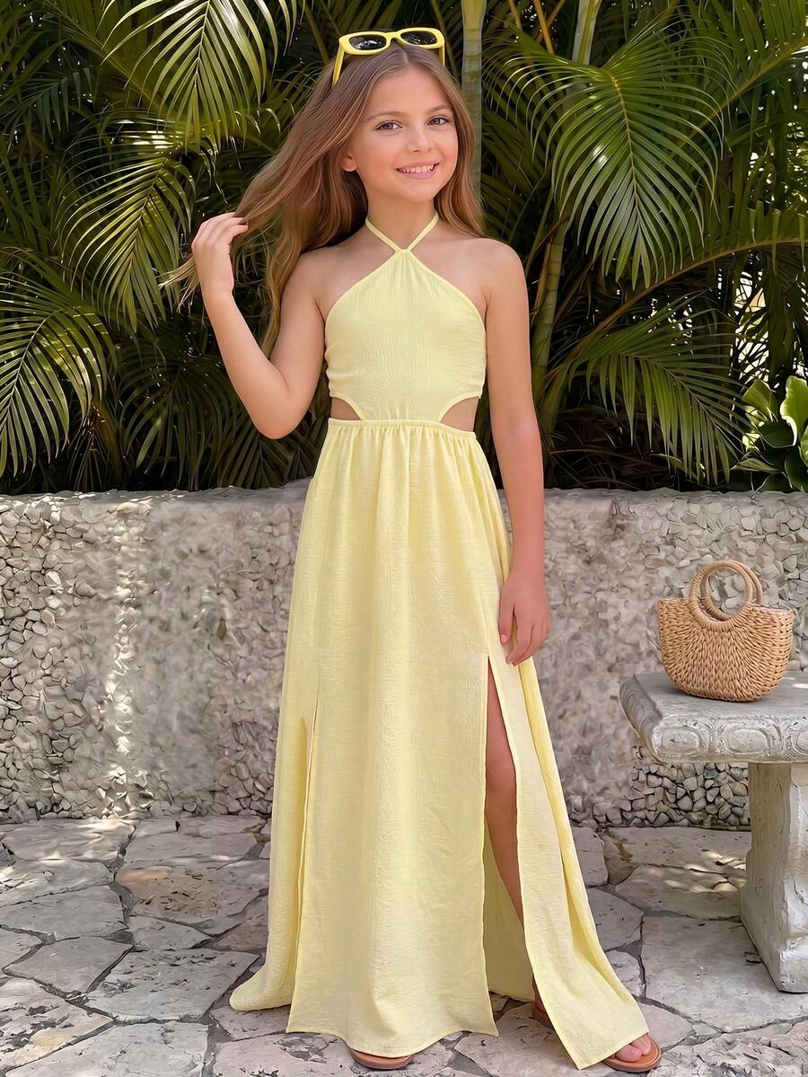 Tween girl yellow long halter dress with cutout waist, split detail, shirred textured fabric, sleeveless design, high waist, and flared hem for beach vacation wear.