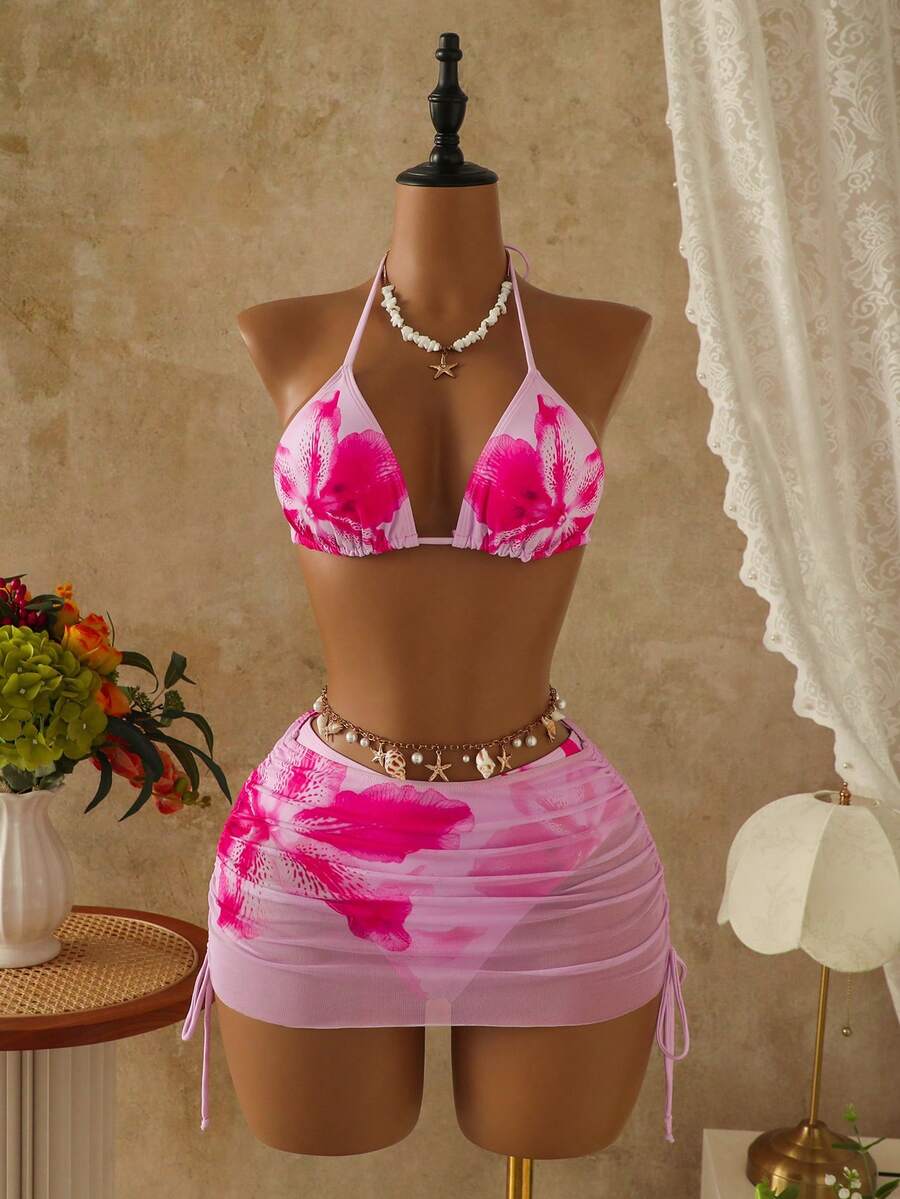 Women's black 3-piece bikini set featuring a halter triangle top with removable padding, high-waisted bottoms, and a knee-length mesh skirt with tie details.