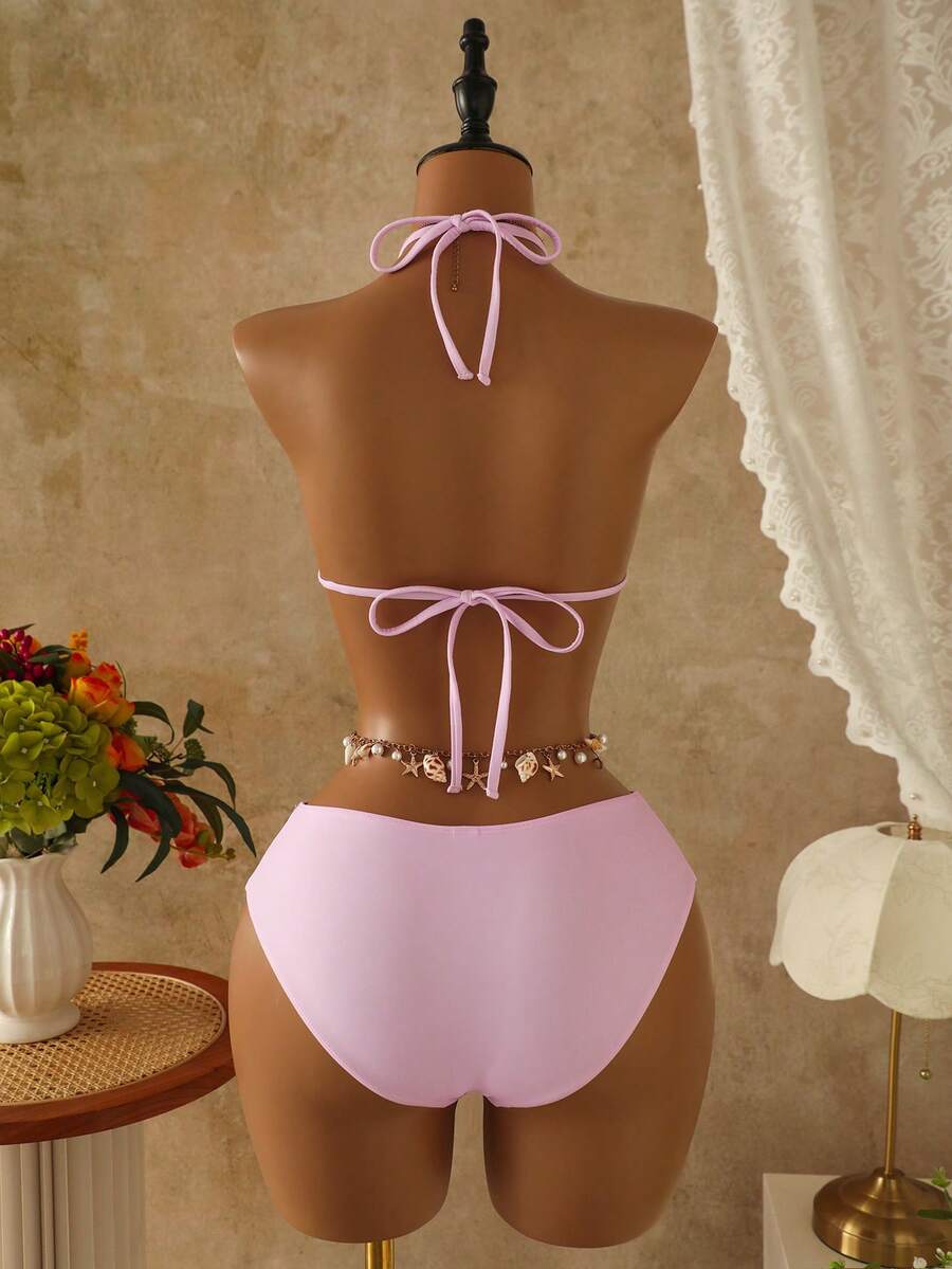 Women's black 3-piece bikini set featuring a halter triangle top with removable padding, high-waisted bottoms, and a knee-length mesh skirt with tie details.