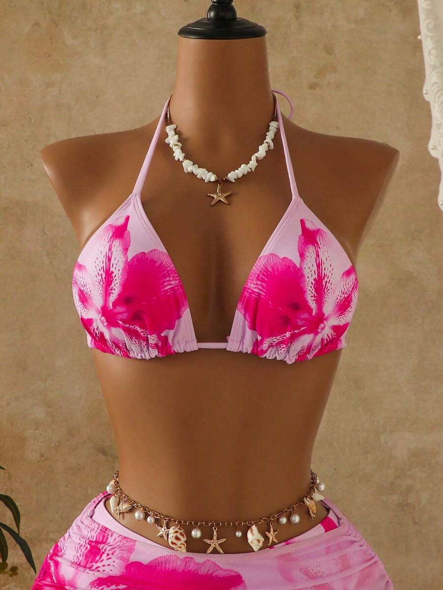 Women's black 3-piece bikini set featuring a halter triangle top with removable padding, high-waisted bottoms, and a knee-length mesh skirt with tie details.