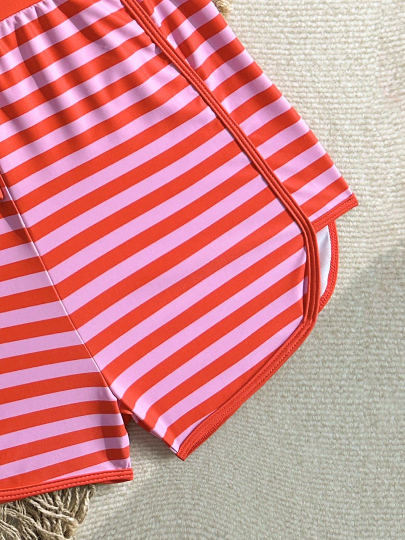 Girls 2-piece swimwear set featuring a butterfly print halter swimsuit top with contrast piping and separate mid-waist shorts; sleeveless, high-stretch, wireless design for beach and vacation wear.