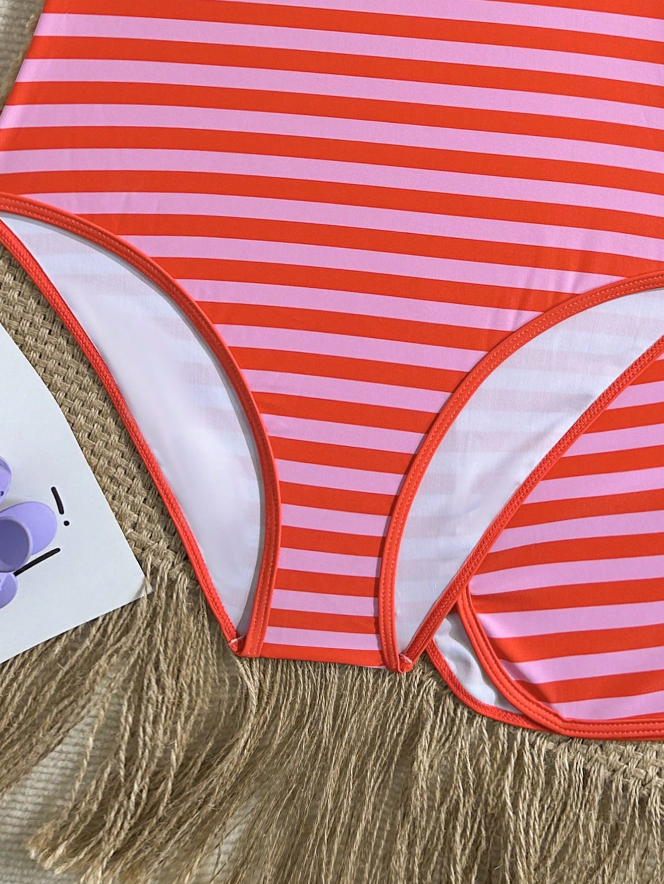 Girls 2-piece swimwear set featuring a butterfly print halter swimsuit top with contrast piping and separate mid-waist shorts; sleeveless, high-stretch, wireless design for beach and vacation wear.