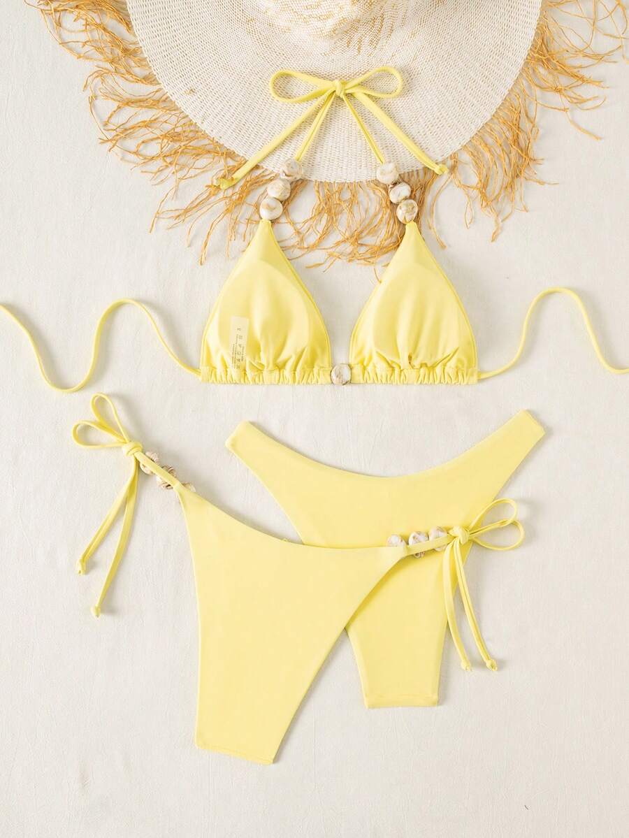 Women's triangle bikini set with contrast lace wireless bra top and ultra high waist tie side bottoms.
