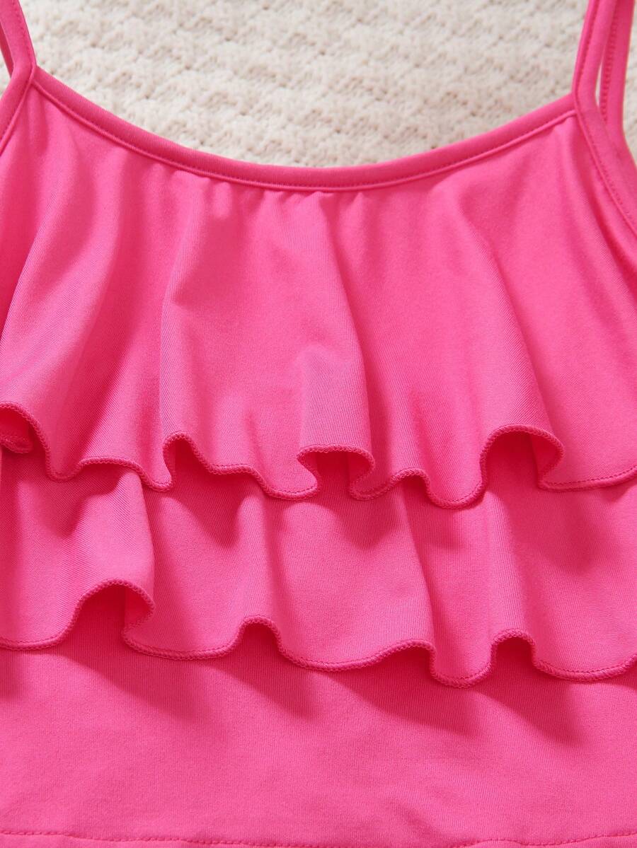 Tween girls blue 2-piece vacation outfit set featuring a tiered ruffle spaghetti strap camisole and loose high-waist pants.