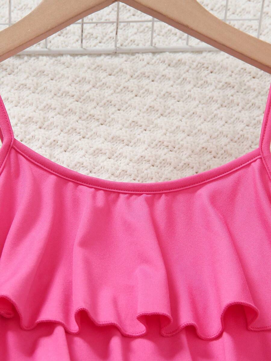 Tween girls blue 2-piece vacation outfit set featuring a tiered ruffle spaghetti strap camisole and loose high-waist pants.
