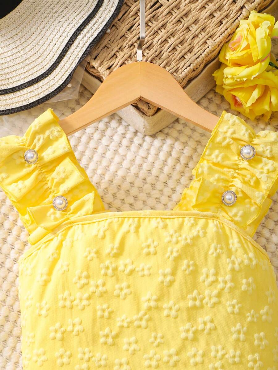 Apricot two-piece summer outfit for tween girls featuring a sleeveless pleated square-neck camisole top with button details and matching gathered shorts.