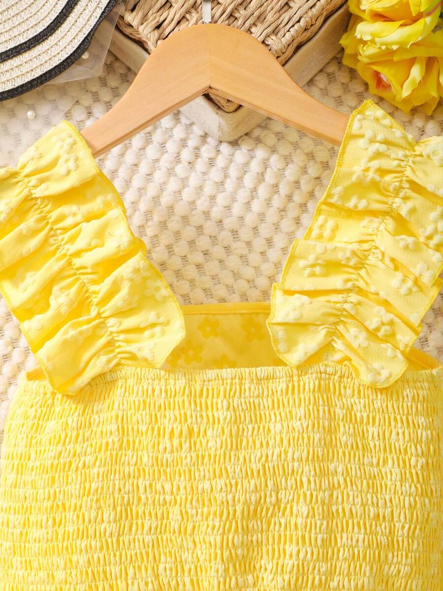Apricot two-piece summer outfit for tween girls featuring a sleeveless pleated square-neck camisole top with button details and matching gathered shorts.