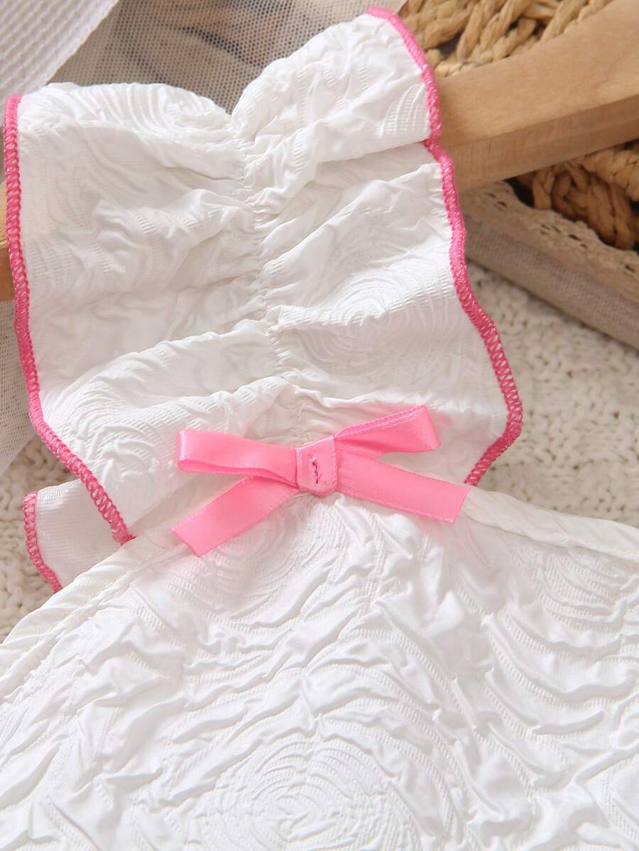 Apricot two-piece summer outfit for tween girls featuring a sleeveless pleated square-neck camisole top with button details and matching gathered shorts.