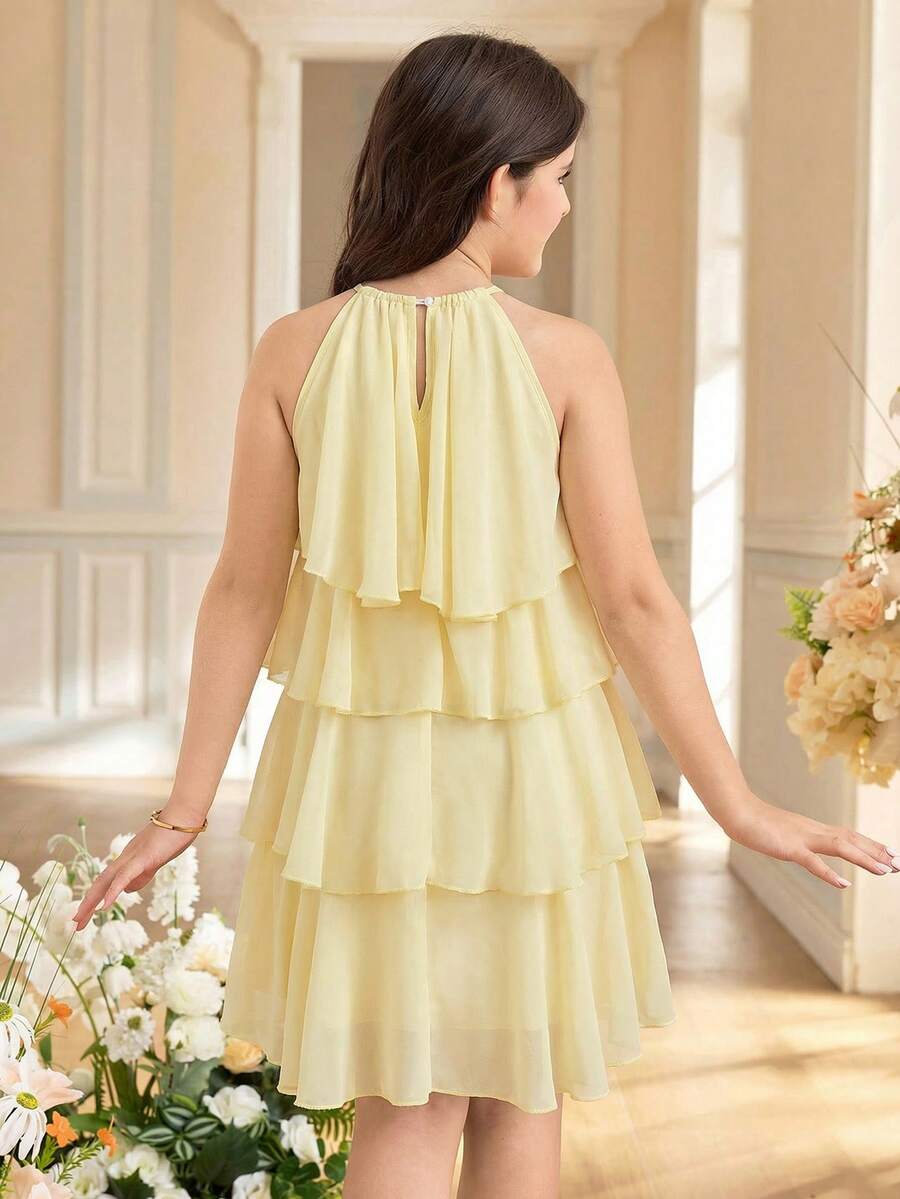 Apricot all-over floral print midi dress for tween girls featuring a sleeveless V-neckline, high waist, button details, and tiered A-line skirt.