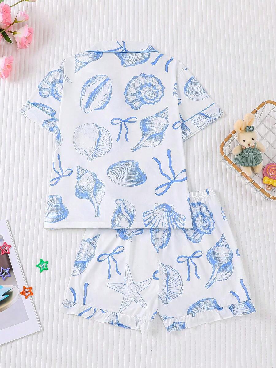 White 2-piece tween girl summer pajama set with blue ocean and seashell print featuring a short sleeve lapel cardigan top and matching elastic waist shorts.