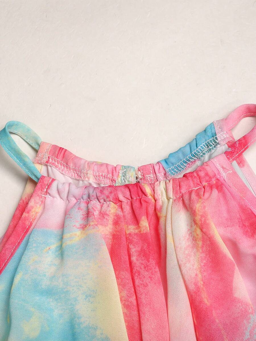 Apricot all-over floral print midi dress for tween girls featuring a sleeveless V-neckline, high waist, button details, and tiered A-line skirt.