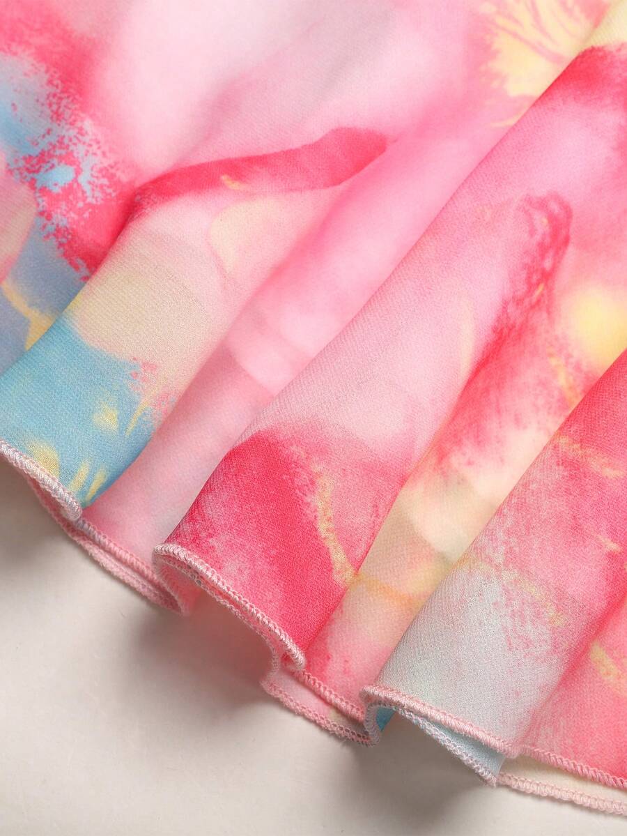 Apricot all-over floral print midi dress for tween girls featuring a sleeveless V-neckline, high waist, button details, and tiered A-line skirt.