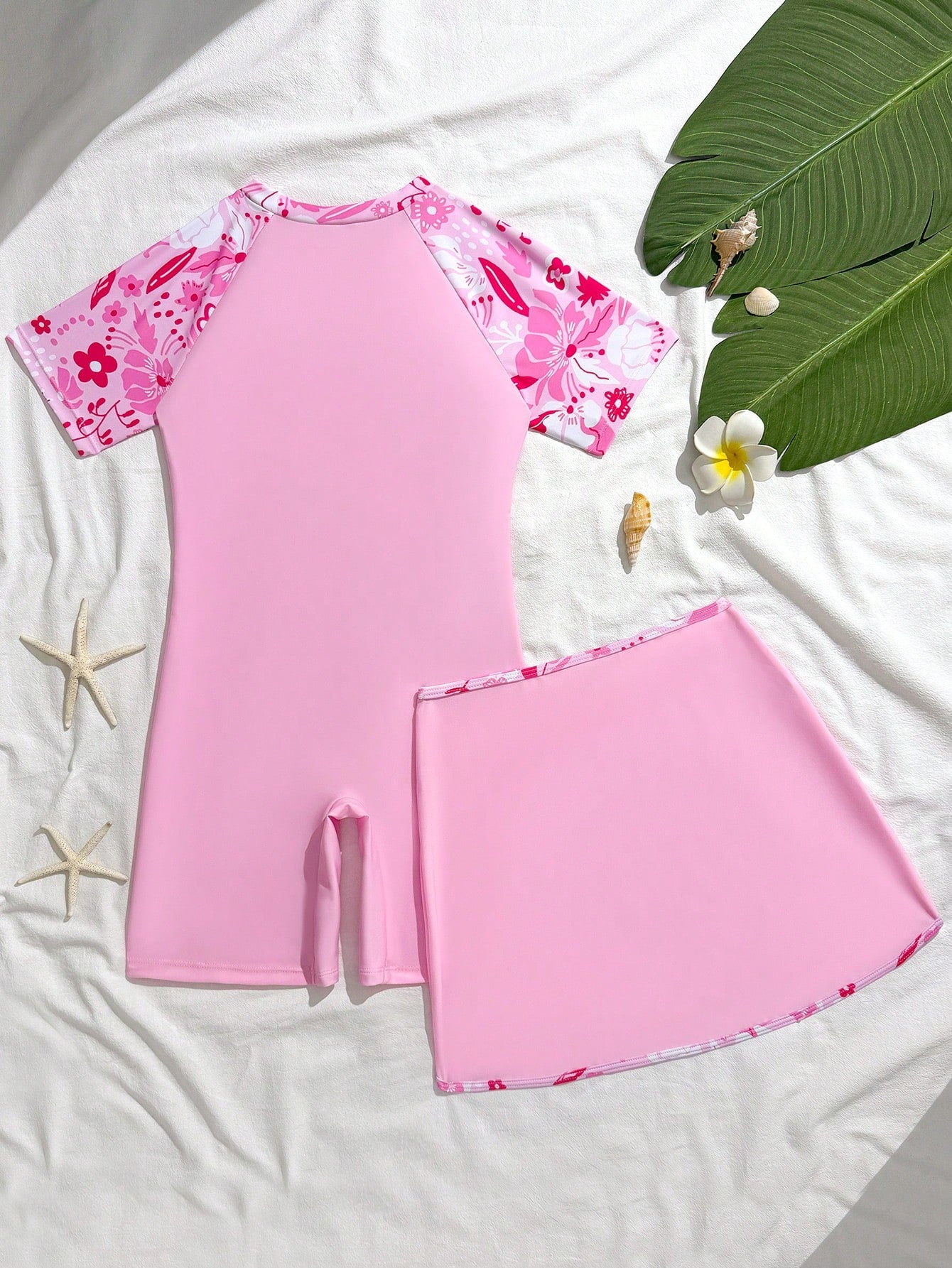 Tween girls' floral print zip-front one-piece swimsuit set with shorts and wrap skirt in baby pink vacation style