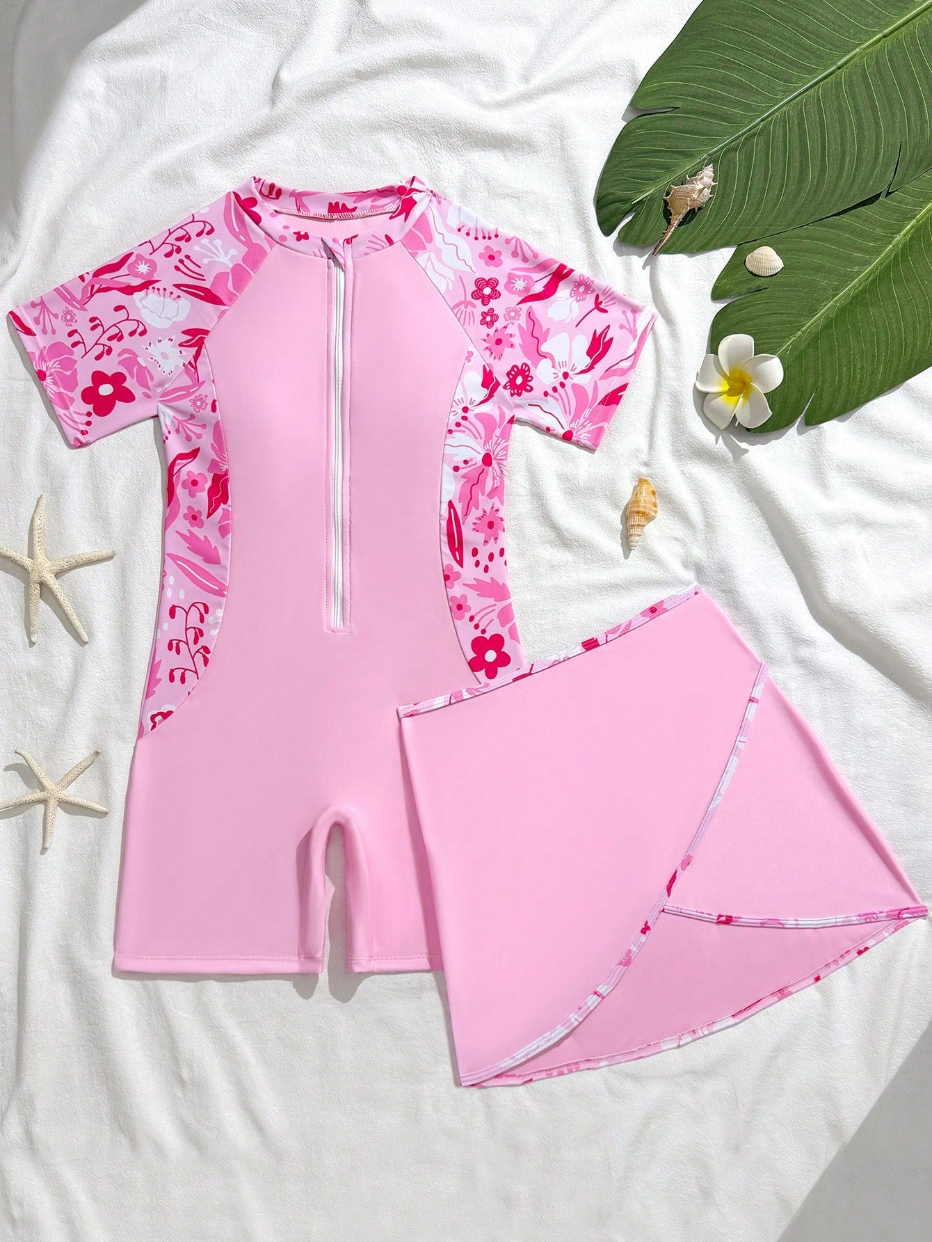 Tween girls' floral print zip-front one-piece swimsuit set with shorts and wrap skirt in baby pink vacation style