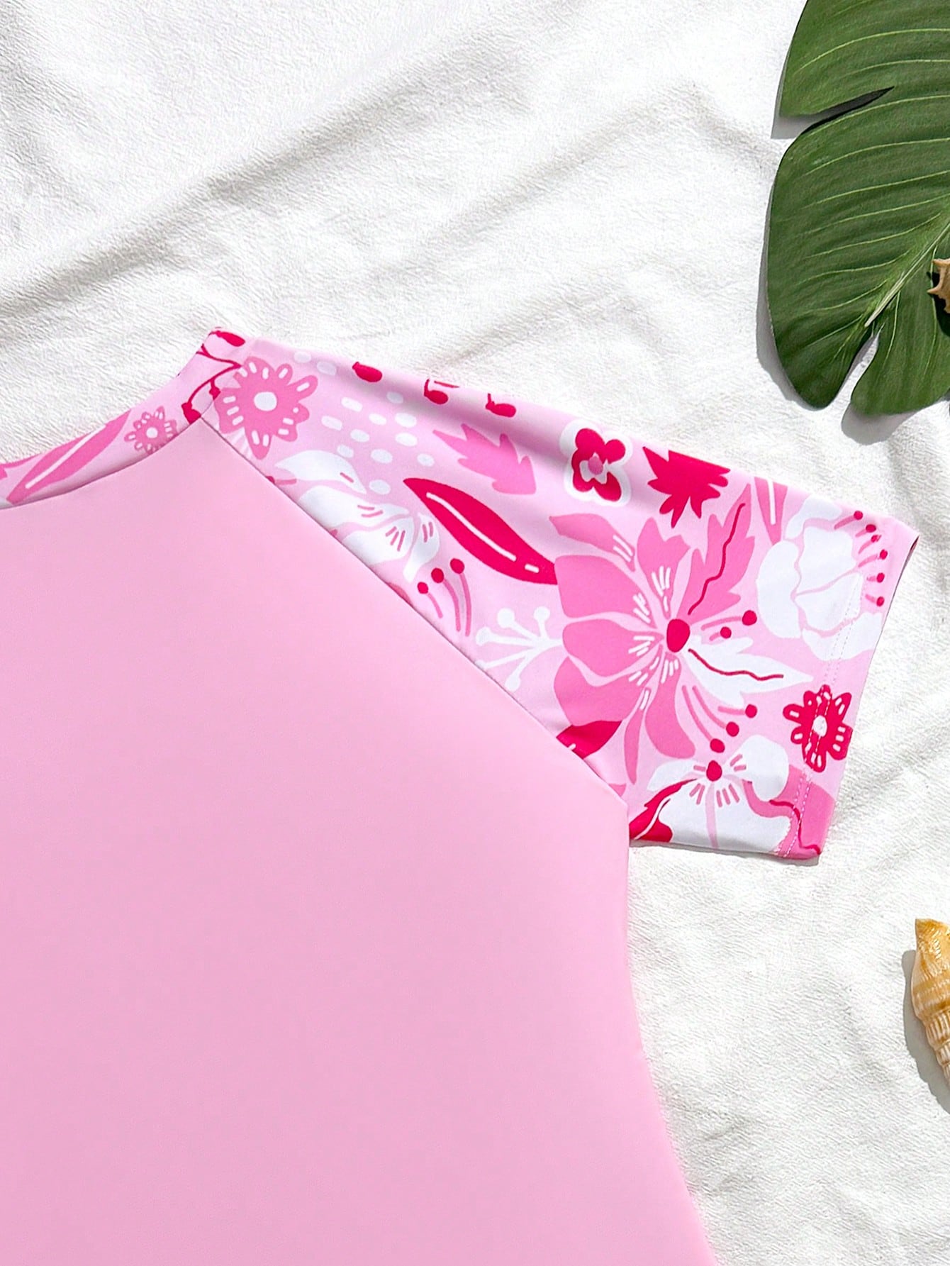 Tween girls' floral print zip-front one-piece swimsuit set with shorts and wrap skirt in baby pink vacation style