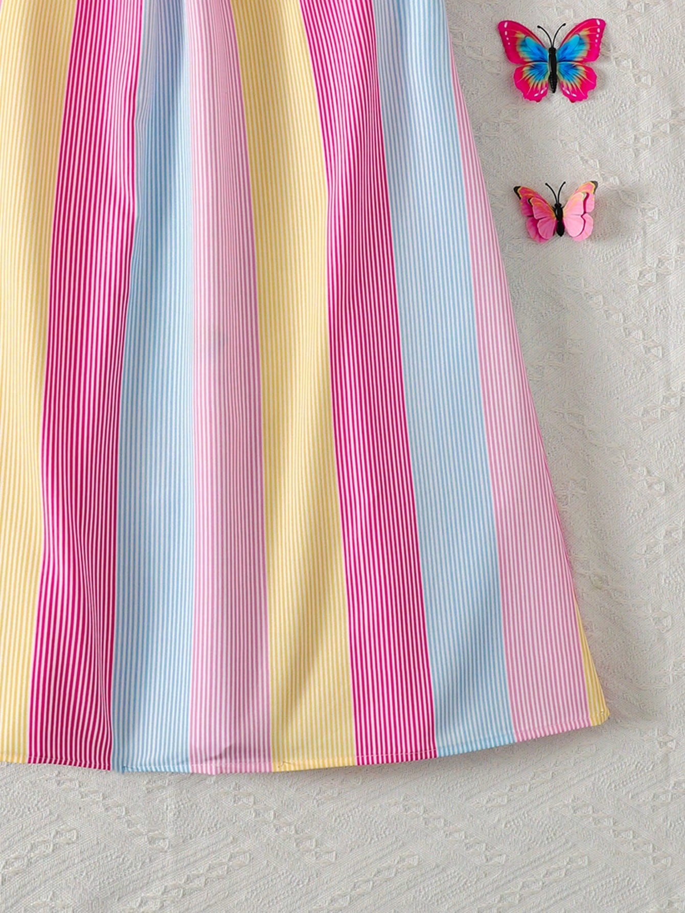 Tween girls sleeveless halter tunic dress with colorful rainbow striped colorblock pattern, button detail, short length, and regular fit for summer vacation or beach wear.