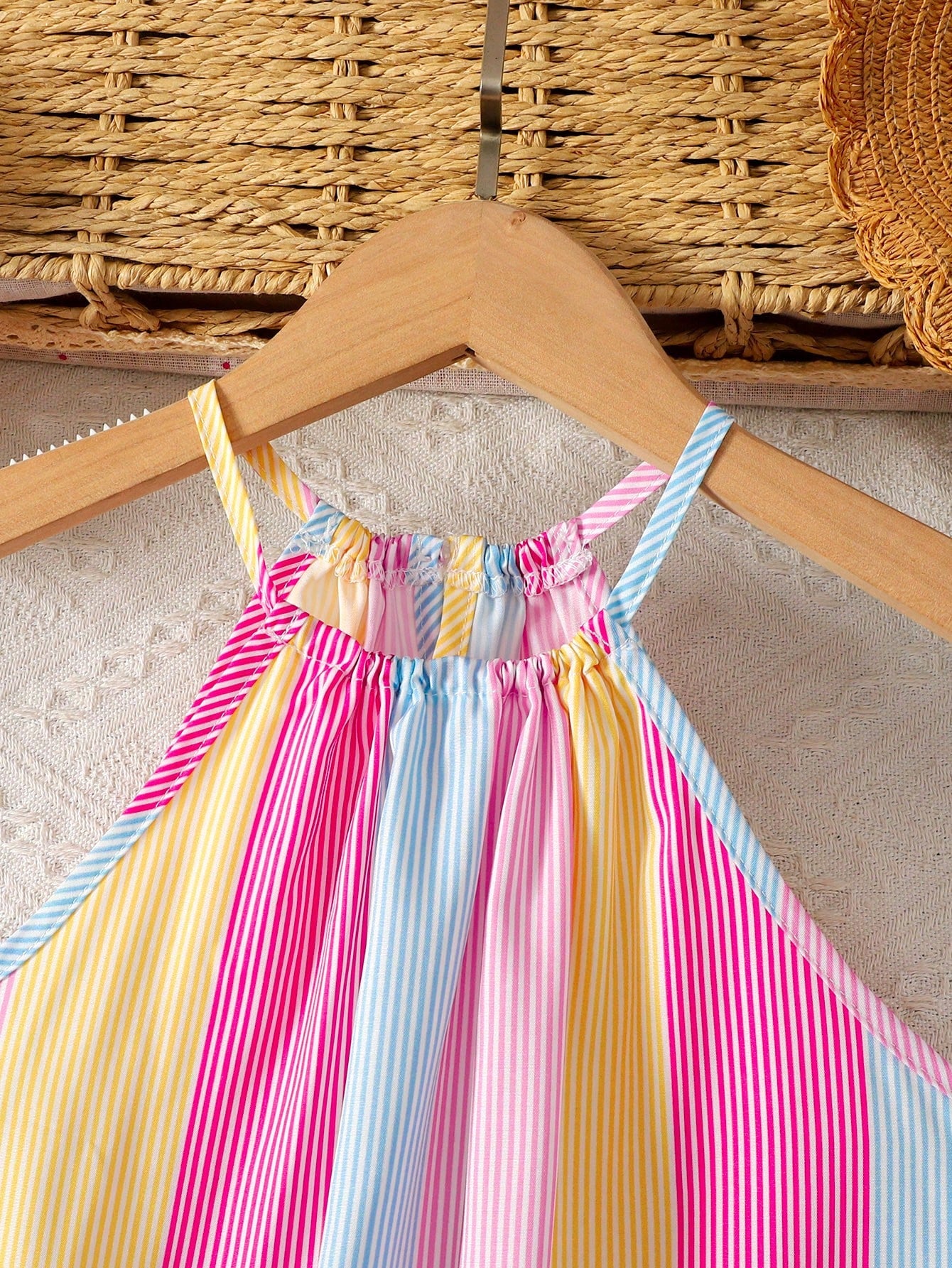 Tween girls sleeveless halter tunic dress with colorful rainbow striped colorblock pattern, button detail, short length, and regular fit for summer vacation or beach wear.