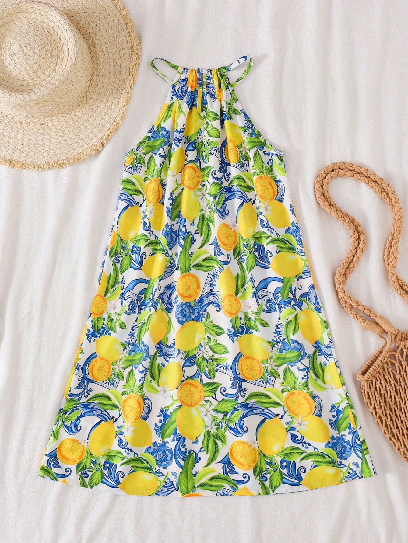 Tween girls floral print dress with halter neckline, sleeveless cold shoulder design, A-line shape, and vacation style.