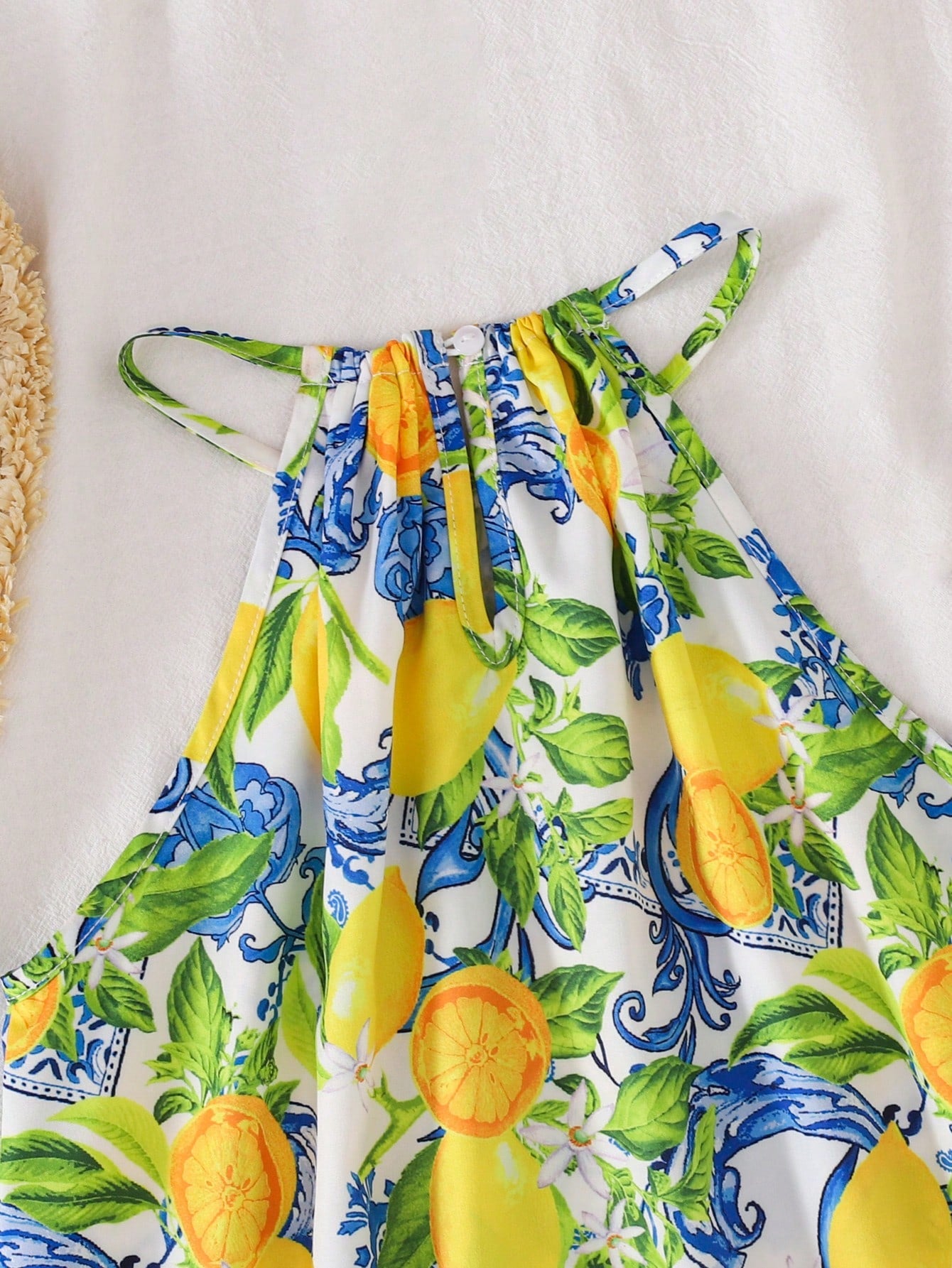 Tween girls floral print dress with halter neckline, sleeveless cold shoulder design, A-line shape, and vacation style.
