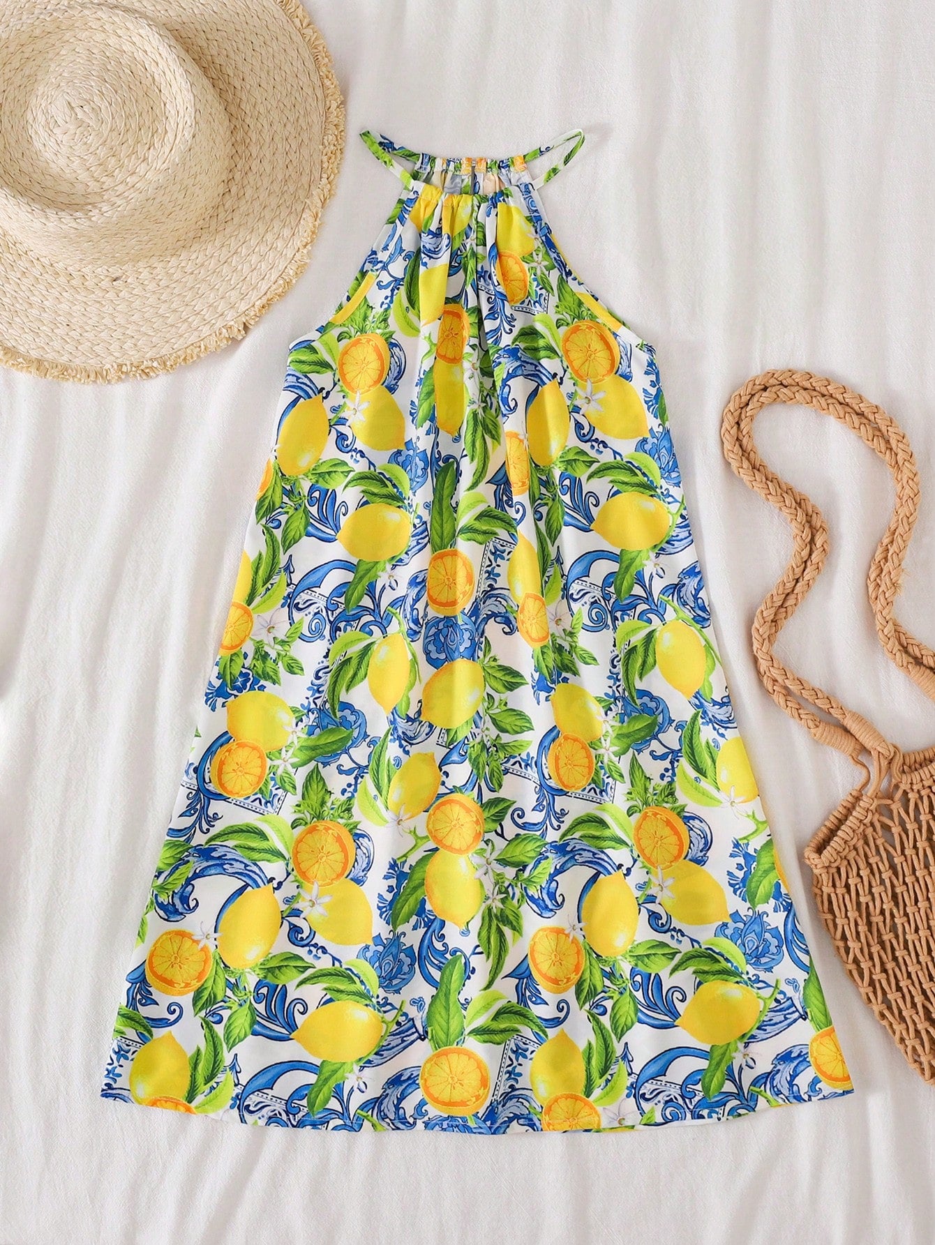 Tween girls floral print dress with halter neckline, sleeveless cold shoulder design, A-line shape, and vacation style.