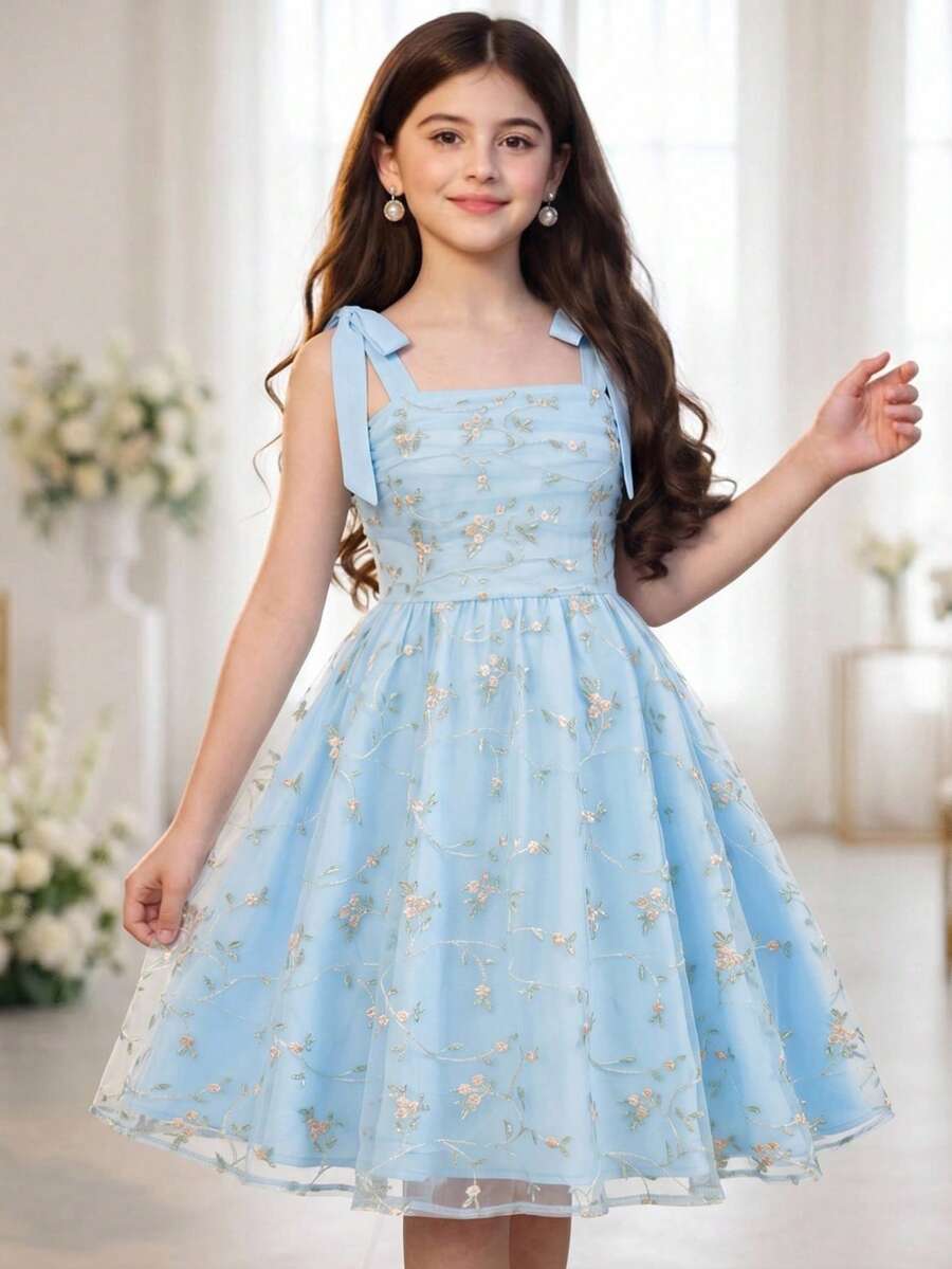 Black and white polka dot cami dress for tween girls featuring sleeveless straps, a shirred high waist, flared hem, and slim fit silhouette.