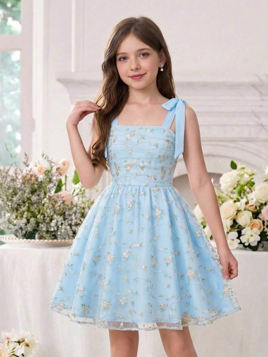Black and white polka dot cami dress for tween girls featuring sleeveless straps, a shirred high waist, flared hem, and slim fit silhouette.