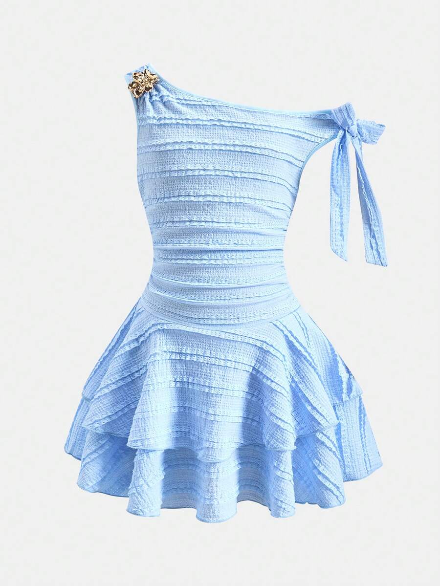 Tween girl wearing an apricot asymmetric skater dress with ruffle and applique details for party and formal occasions.