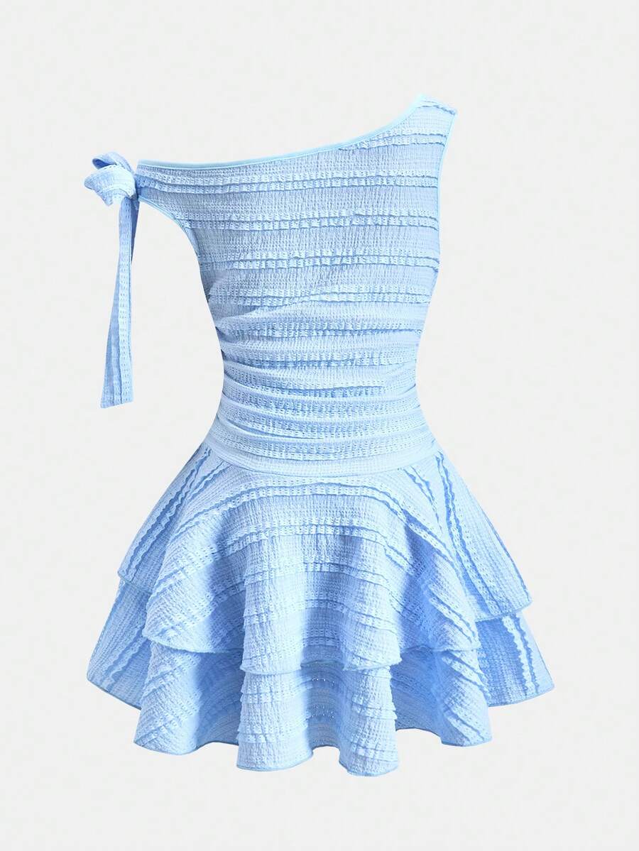 Tween girl wearing an apricot asymmetric skater dress with ruffle and applique details for party and formal occasions.