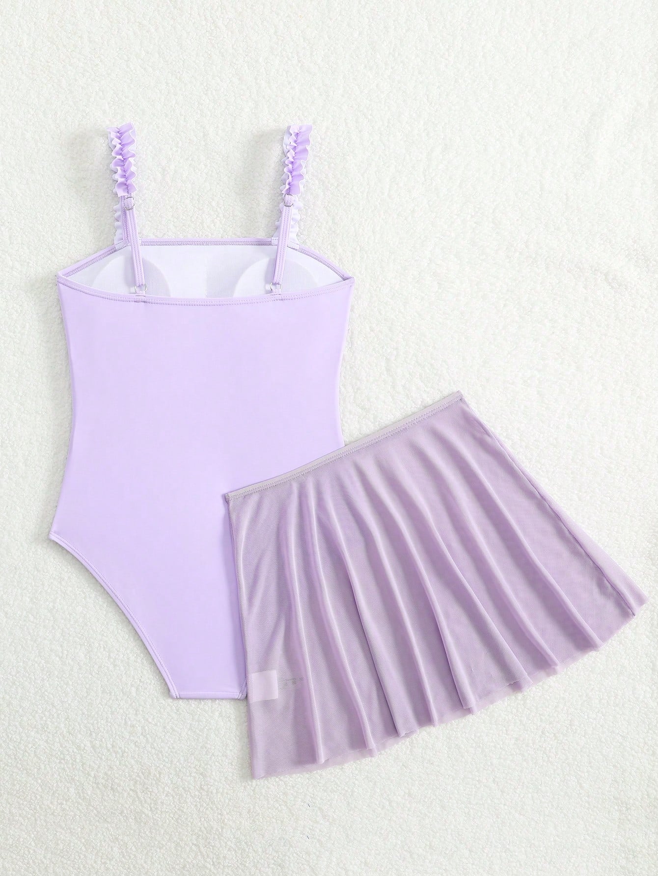 Girls floral print swimsuit set with strap neckline, sleeveless fitted top, and pleated mesh skirt bottom for beach and summer vacation wear.