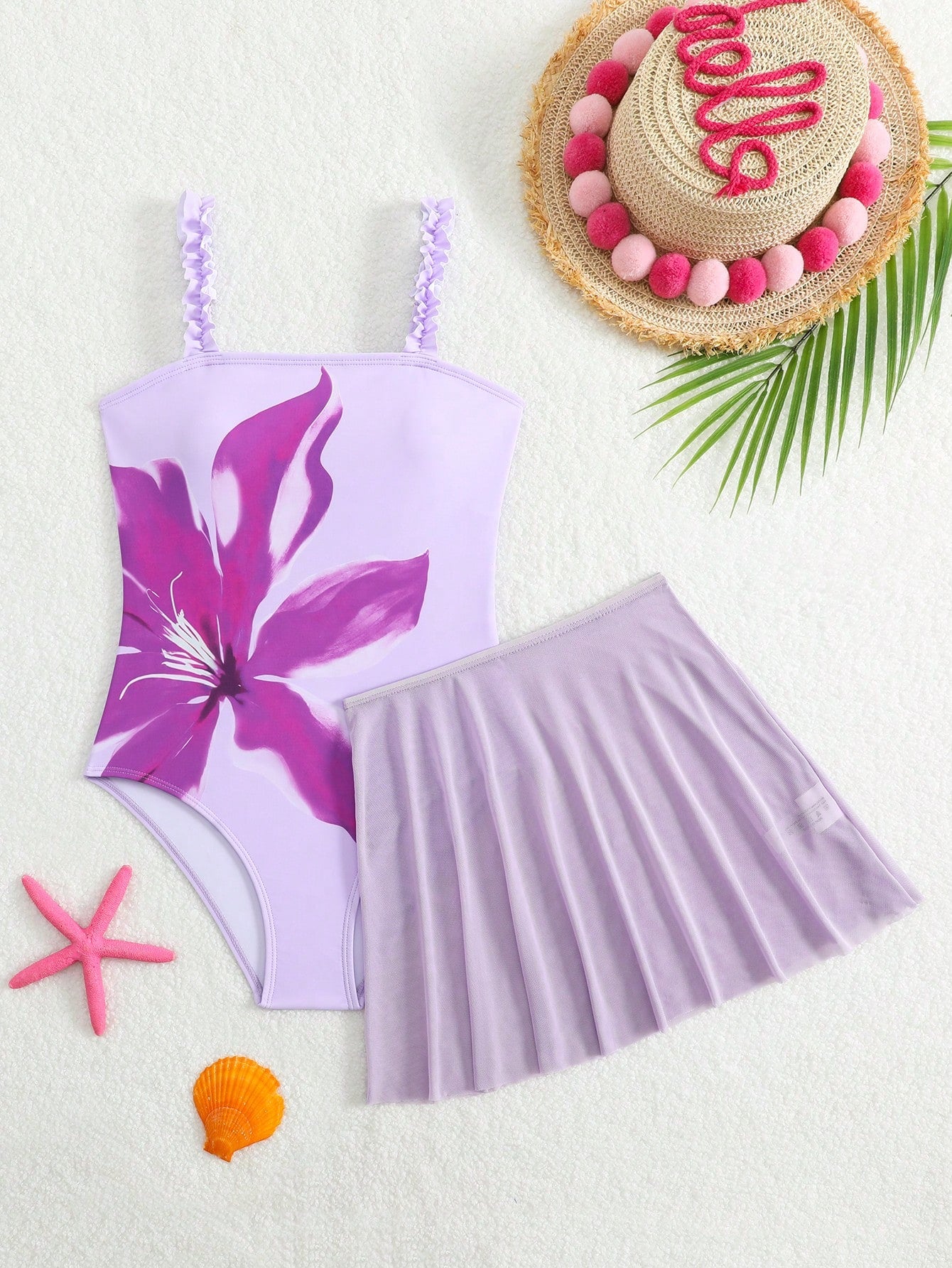 Girls floral print swimsuit set with strap neckline, sleeveless fitted top, and pleated mesh skirt bottom for beach and summer vacation wear.