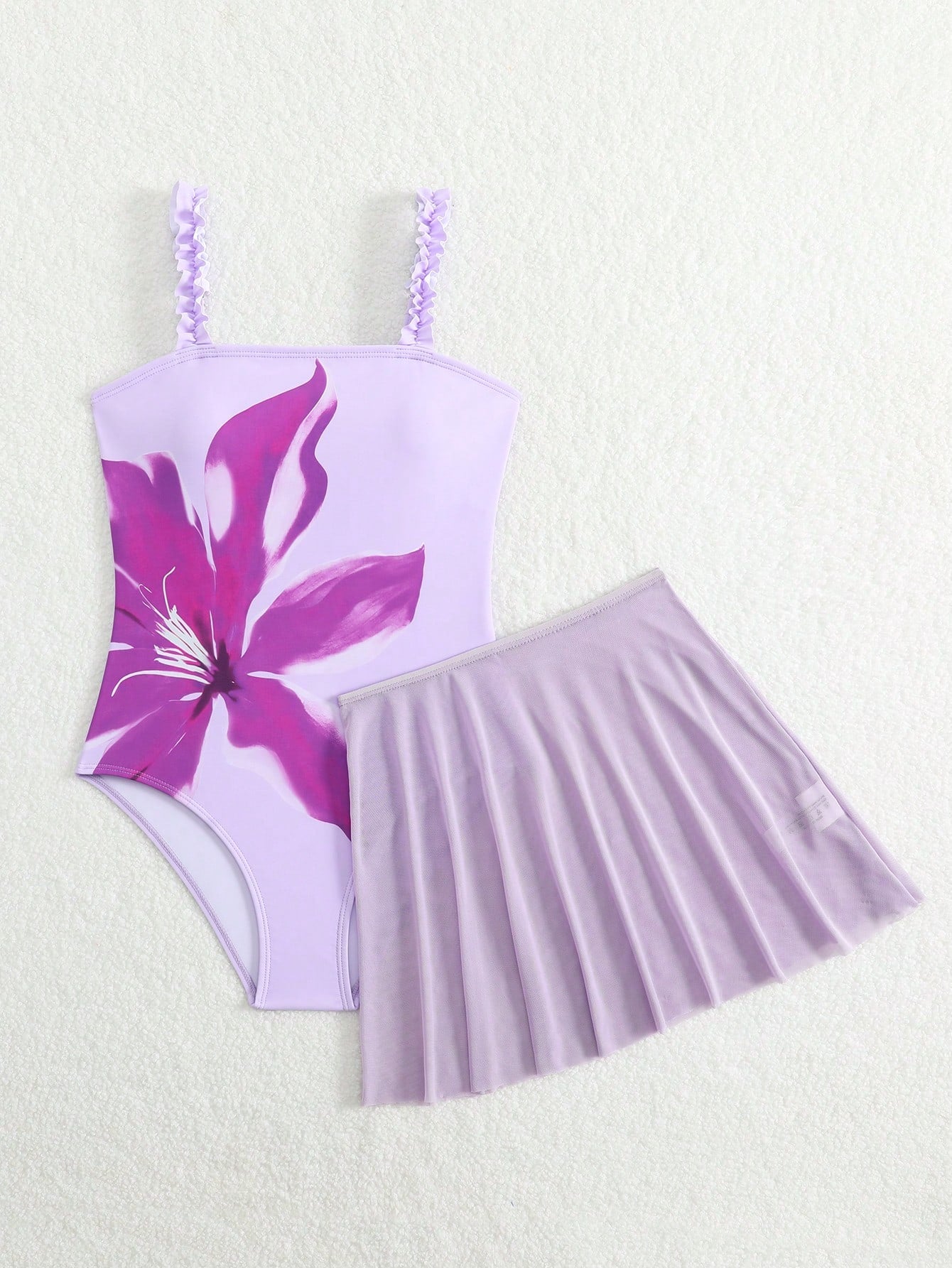 Girls floral print swimsuit set with strap neckline, sleeveless fitted top, and pleated mesh skirt bottom for beach and summer vacation wear.