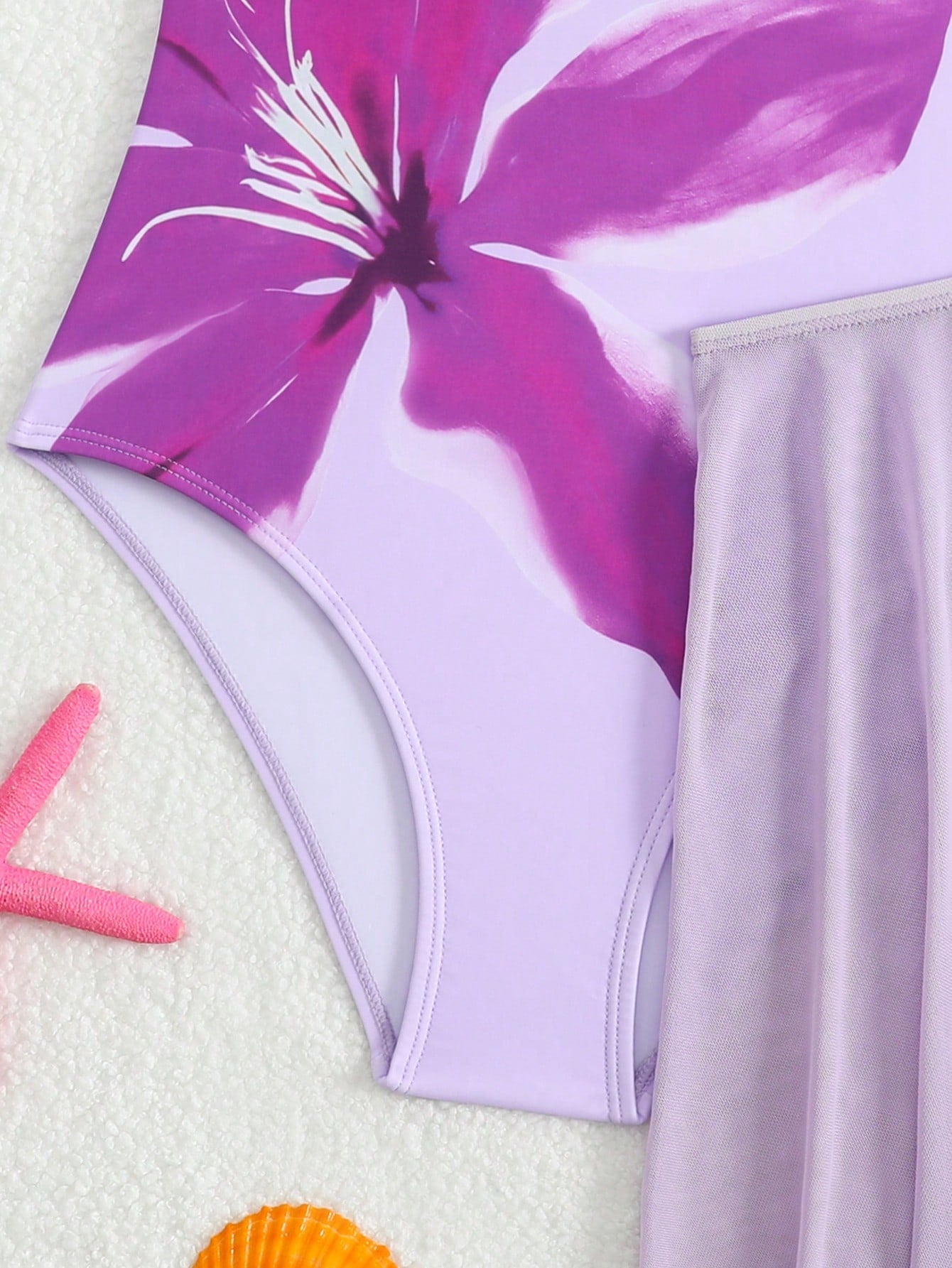 Girls floral print swimsuit set with strap neckline, sleeveless fitted top, and pleated mesh skirt bottom for beach and summer vacation wear.