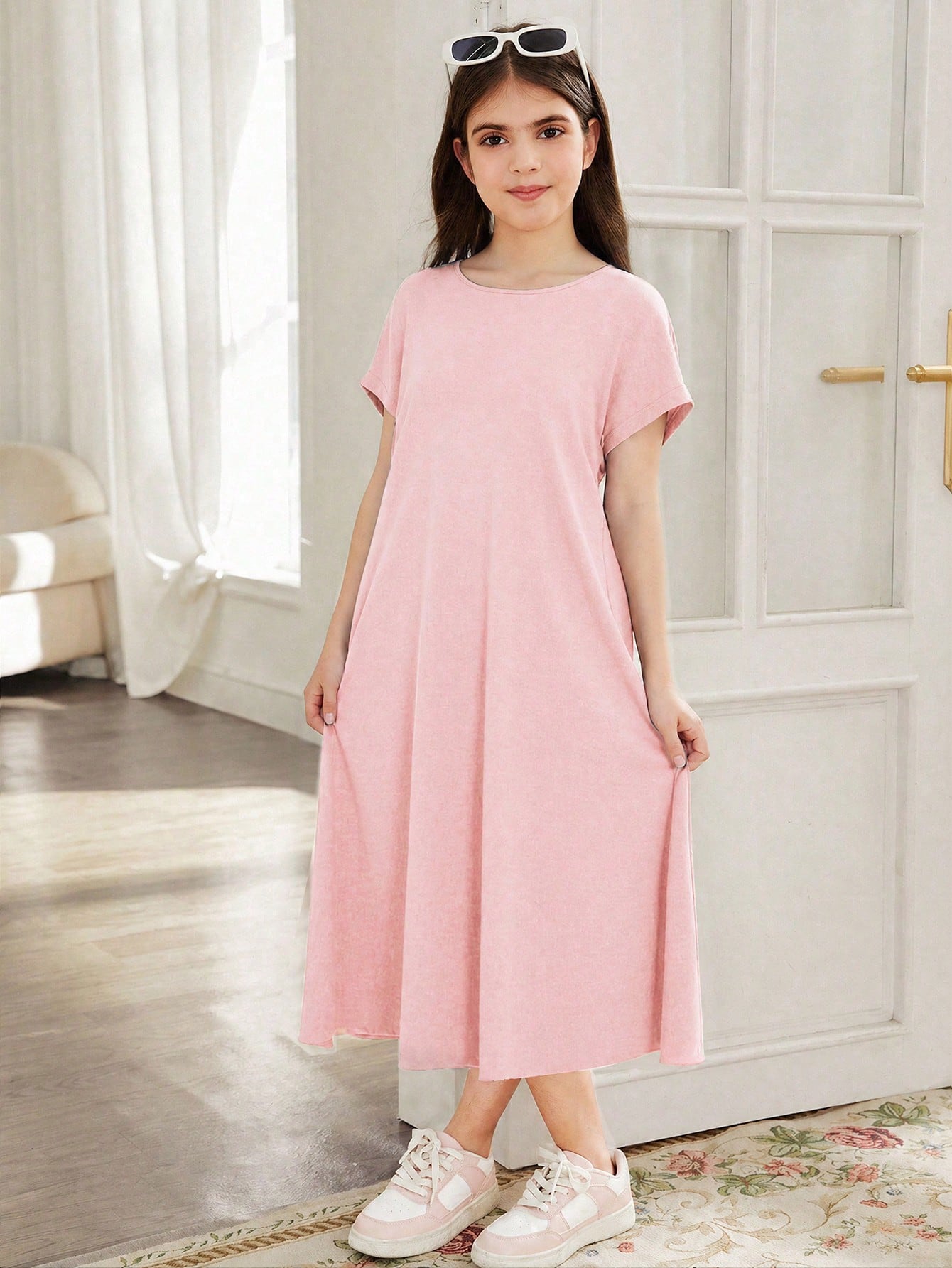 Tween girls casual black A-line long dress featuring short sleeves, a round neckline, and a decorative front bow with contrast lace trim.