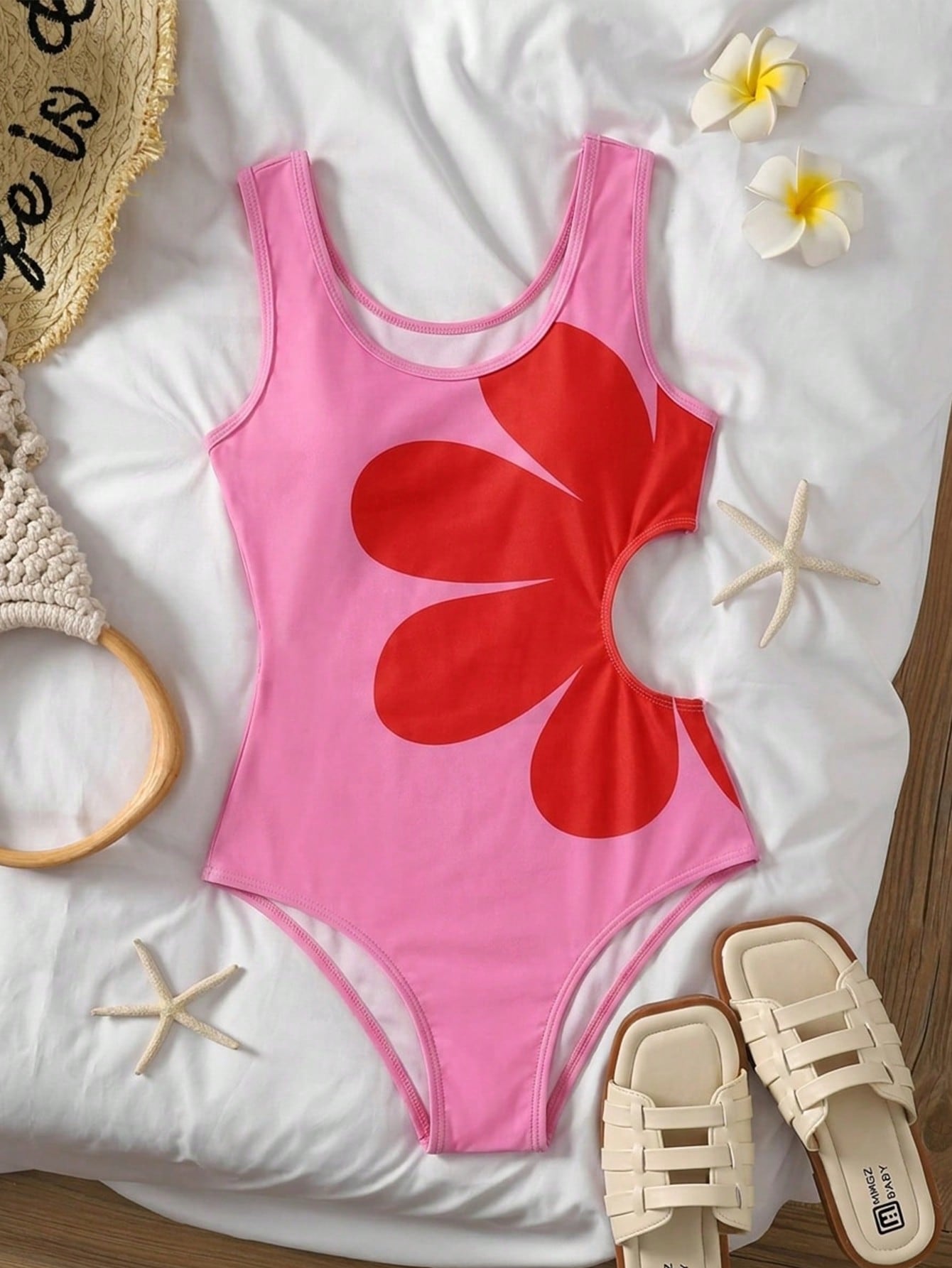 Tween girls' black and white one-piece swimsuit with striped patchwork design, scoop neck, asymmetrical cut-out detail, and fitted vacation swimwear style.