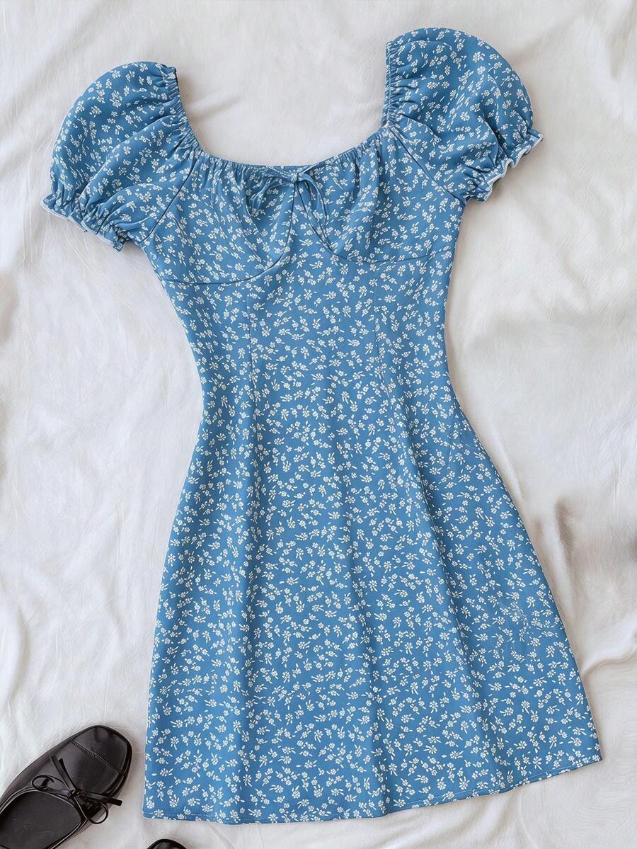 Black floral all-over print midi dress for tween girls featuring puff half sleeves, spaghetti strap neckline, and an A-line silhouette.