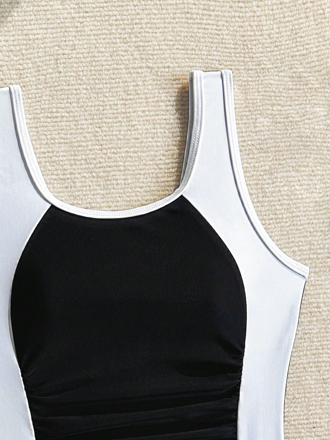 Tween girls one-piece swimsuit with scoop neck, contrast piping, short length, and shorts bottom for summer beach and vacation wear