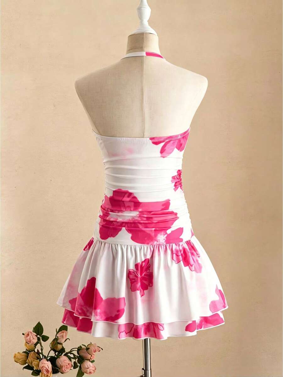 Tween girl black mini dress with halter neckline, backless design, tiered layer detail, high waist, flounce hem, and sleeveless slim fit.