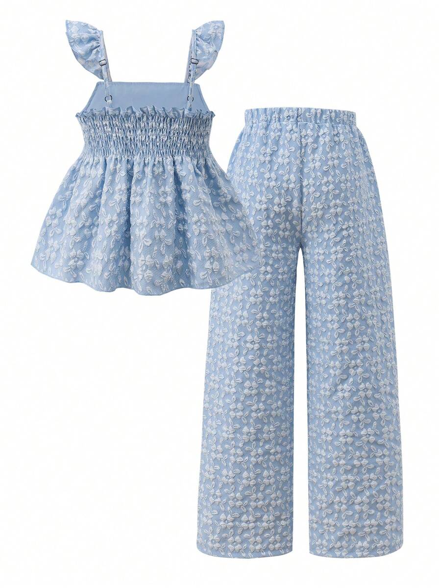 Tween girl wearing an apricot 2-piece outfit set featuring a shirred spaghetti strap short cami top and matching wide-leg long pants.