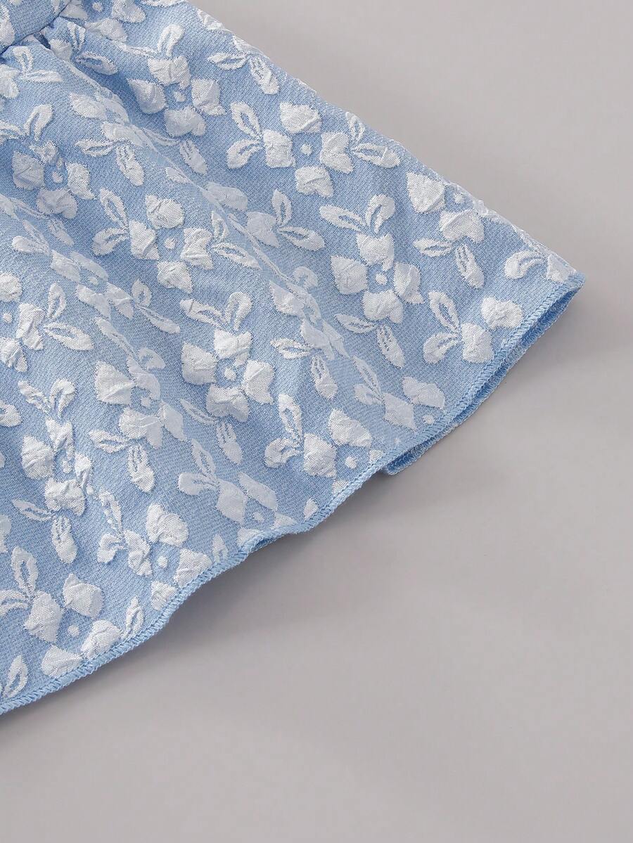 Tween girl wearing an apricot 2-piece outfit set featuring a shirred spaghetti strap short cami top and matching wide-leg long pants.