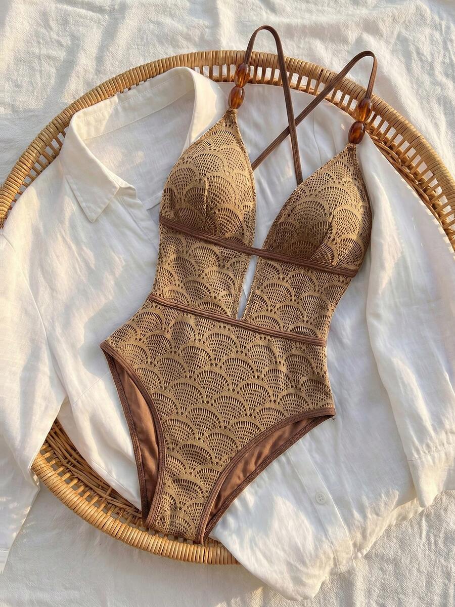 Women's fresh green boho one-piece swimsuit featuring a lace-up V-neckline, textured stretch fabric, and sleeveless design for beach and vacation wear.