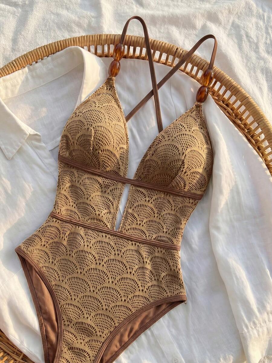 Women's fresh green boho one-piece swimsuit featuring a lace-up V-neckline, textured stretch fabric, and sleeveless design for beach and vacation wear.