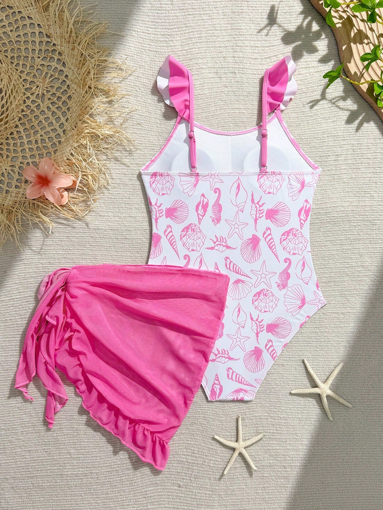 Tween girls one-piece swimsuit in leopard print with ruffle shoulder straps, scoop neckline, fitted shape, and attached ruffle hem skirt; sleeveless, mid-waist skirt bottom, and lined body for swimming, vacation, and summer beach wear.