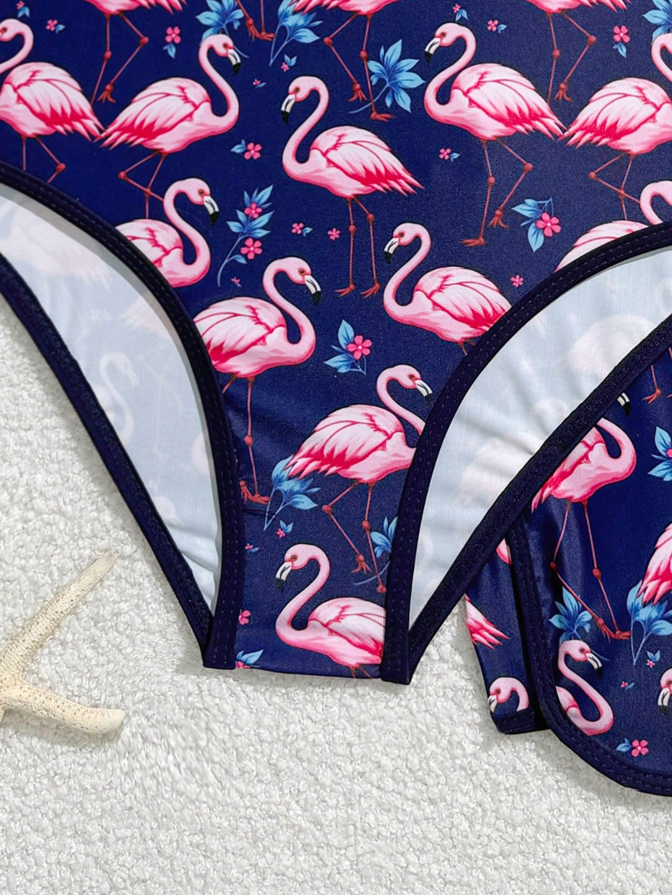 Girls 2-piece swimwear set featuring a butterfly print halter swimsuit top with contrast piping and separate mid-waist shorts; sleeveless, high-stretch, wireless design for beach and vacation wear.