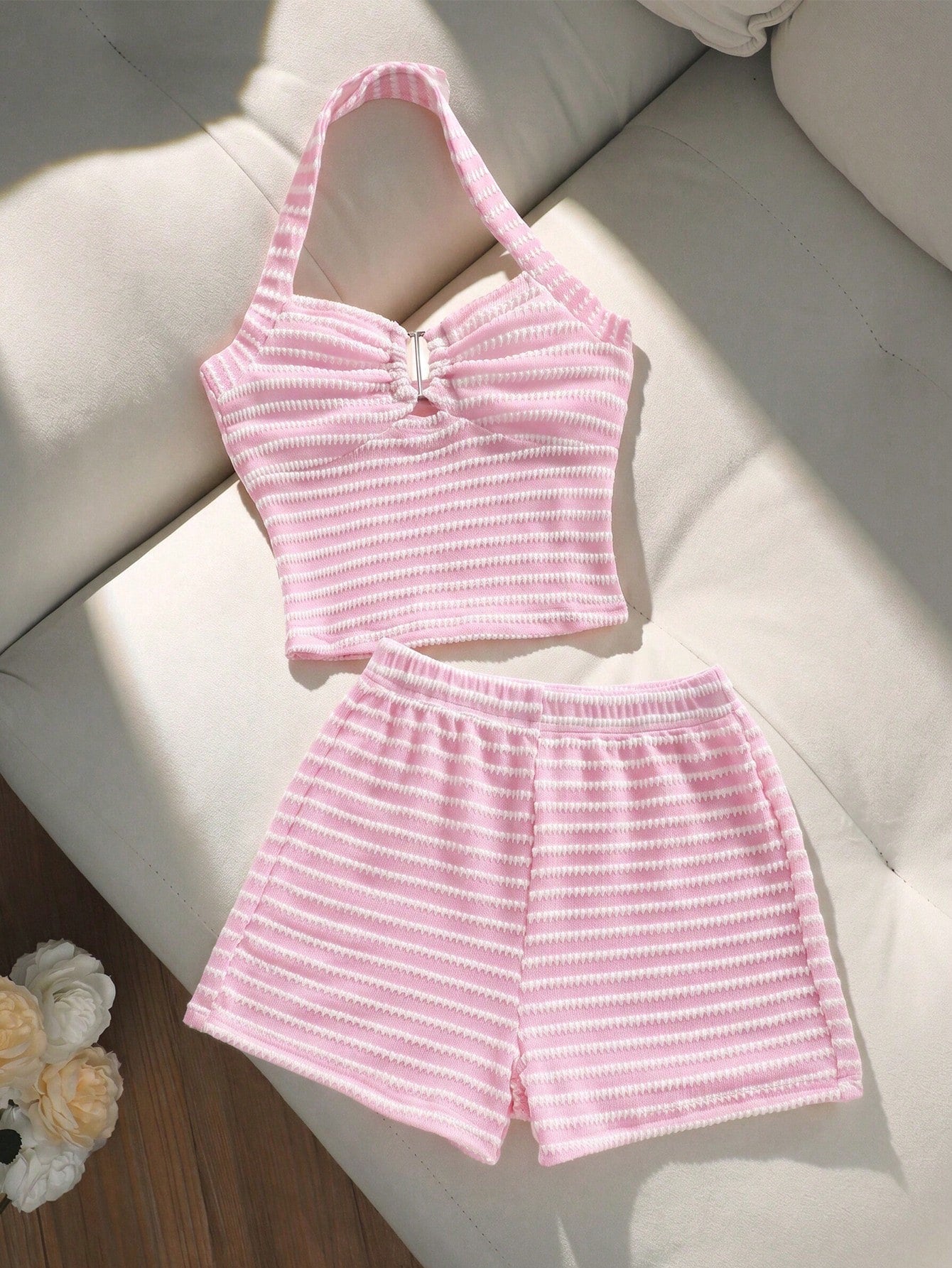 Tween girls black and white striped two-piece set featuring a spaghetti strap micro crop tank top with lettuce trim and ruffle hem paired with matching slim fit shorts.