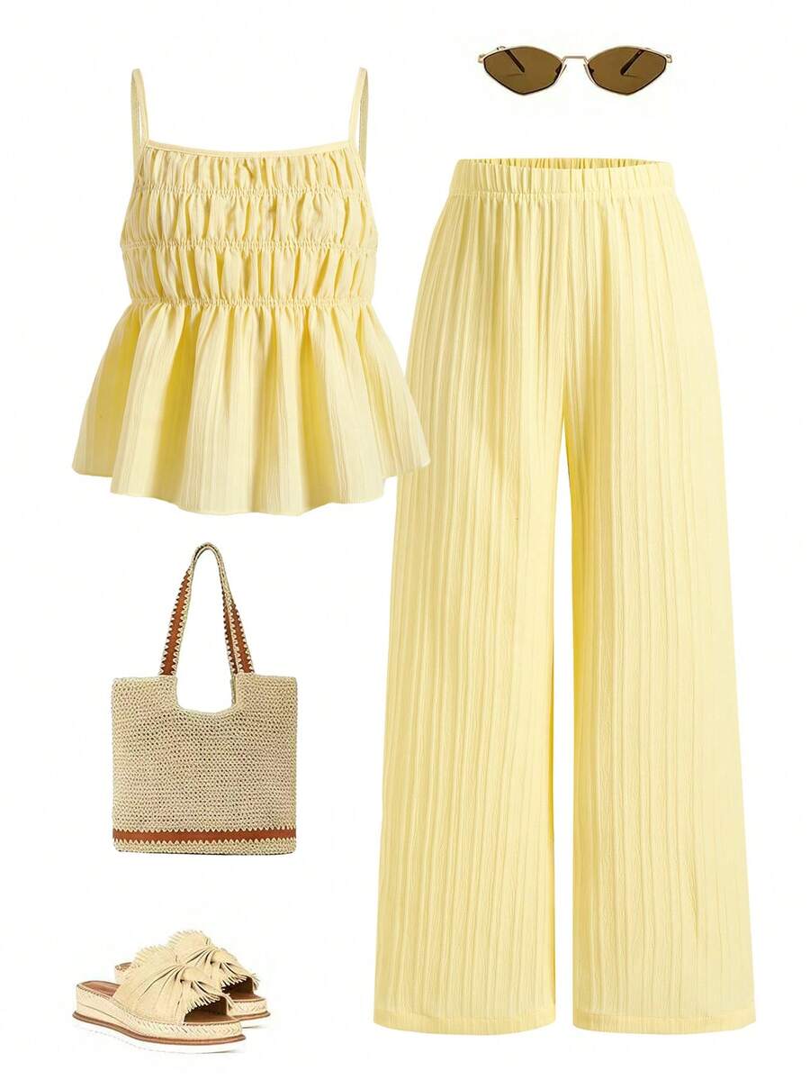 Tween girl wearing an apricot 2-piece outfit set featuring a shirred spaghetti strap short cami top and matching wide-leg long pants.