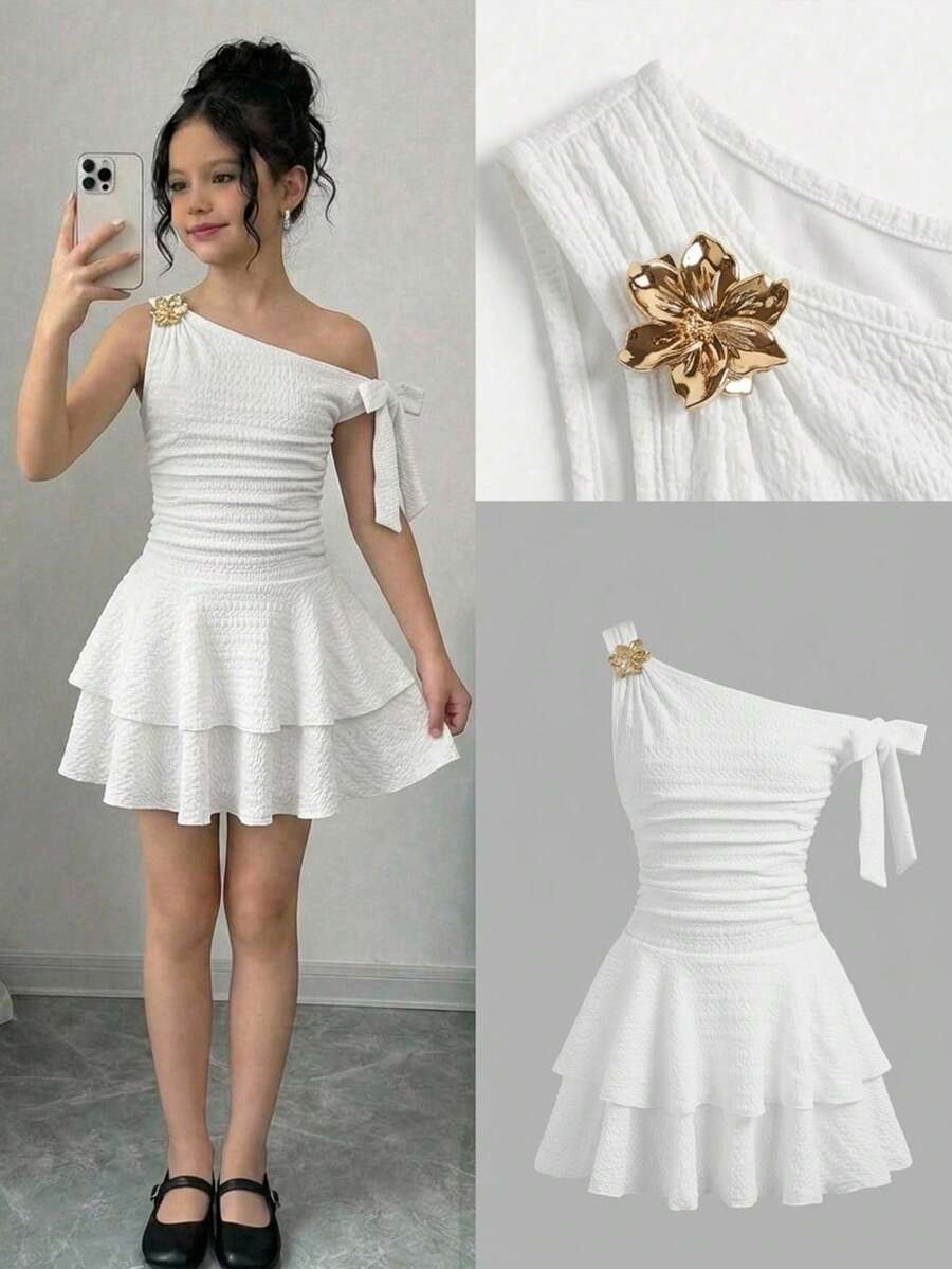 Tween girl wearing an apricot asymmetrical tiered sleeveless party dress with an A-line silhouette.