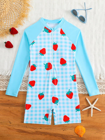 Tween girls one-piece swimsuit featuring a high neck, long sleeves, and shorts bottom, with a back zipper and strawberry plaid digital print on stretch knit fabric. Designed for swimming, vacation, and summer wear.