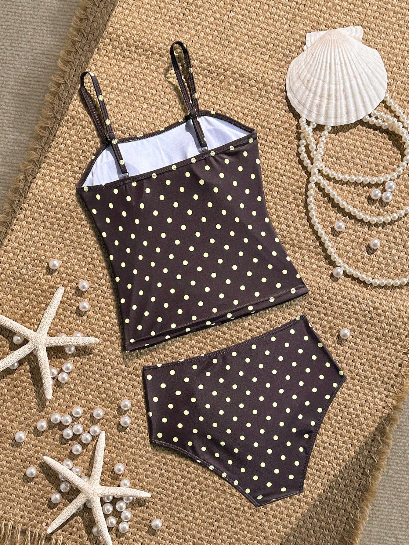 Tween girls 2-piece bikini swimwear set in black with a wave-pattern geometric design, featuring halter neckline, wireless top, and high-waist short bottoms with starfish and shell decor.