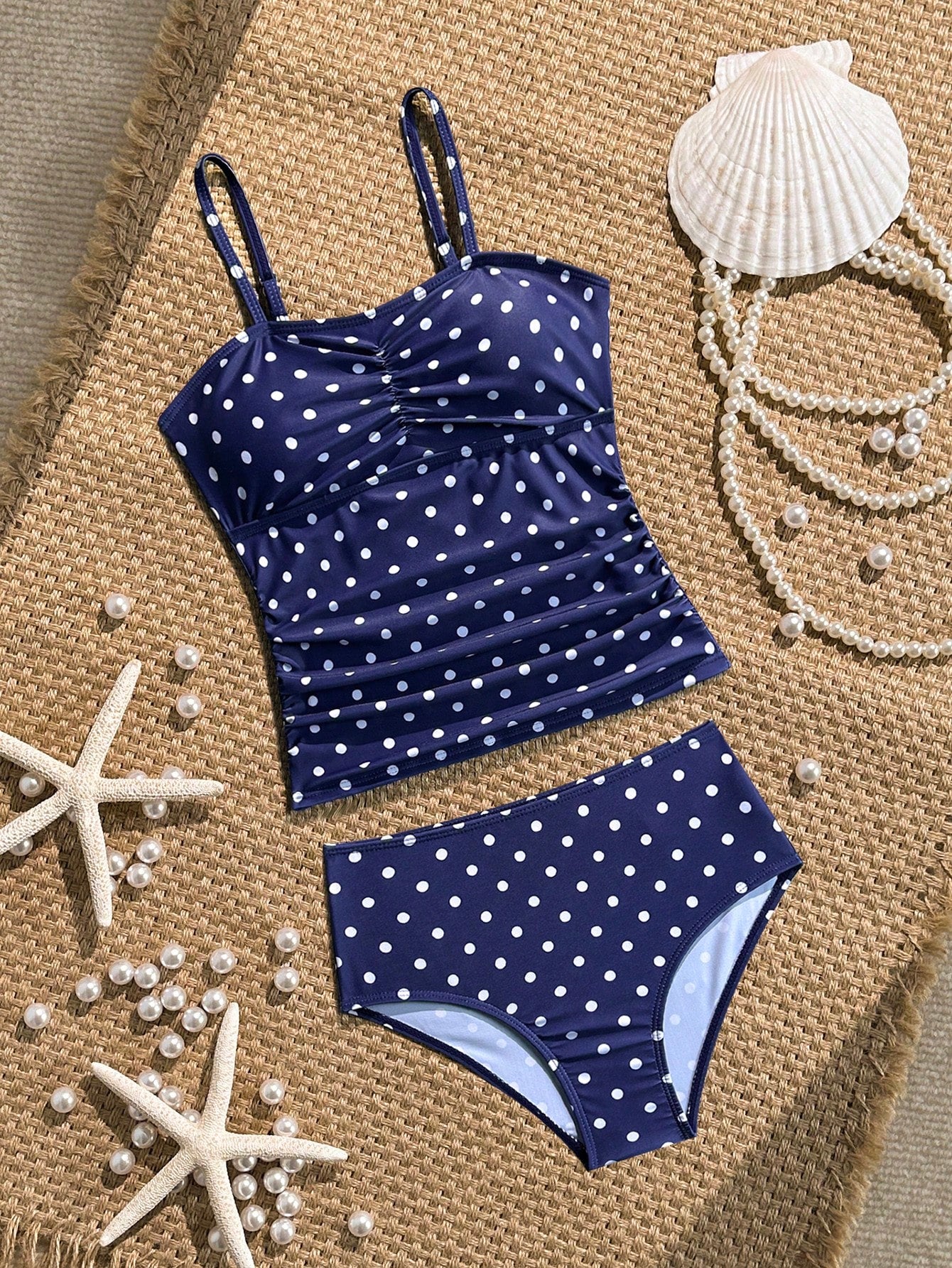 Tween girls 2-piece bikini swimwear set in black with a wave-pattern geometric design, featuring halter neckline, wireless top, and high-waist short bottoms with starfish and shell decor.